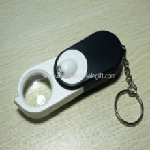 Belyst förstoringsglas med ficklampa och pengar detektor images